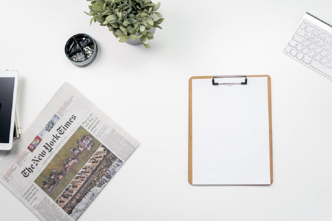 Table with newspaper and paper