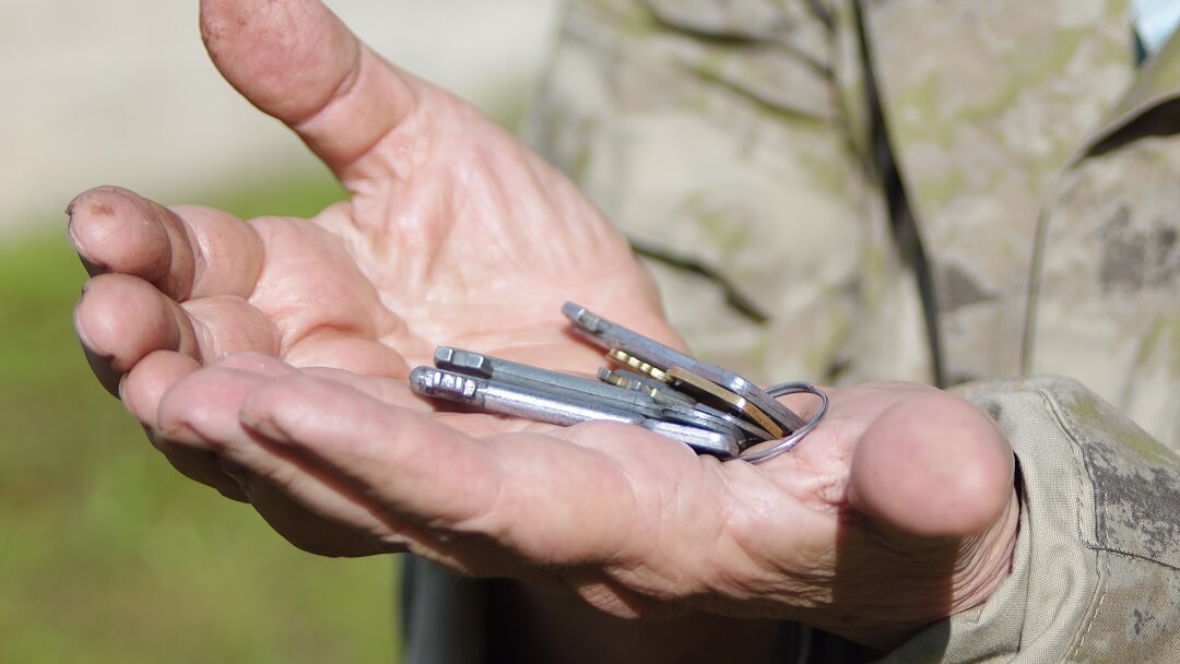 Military person holding a house key