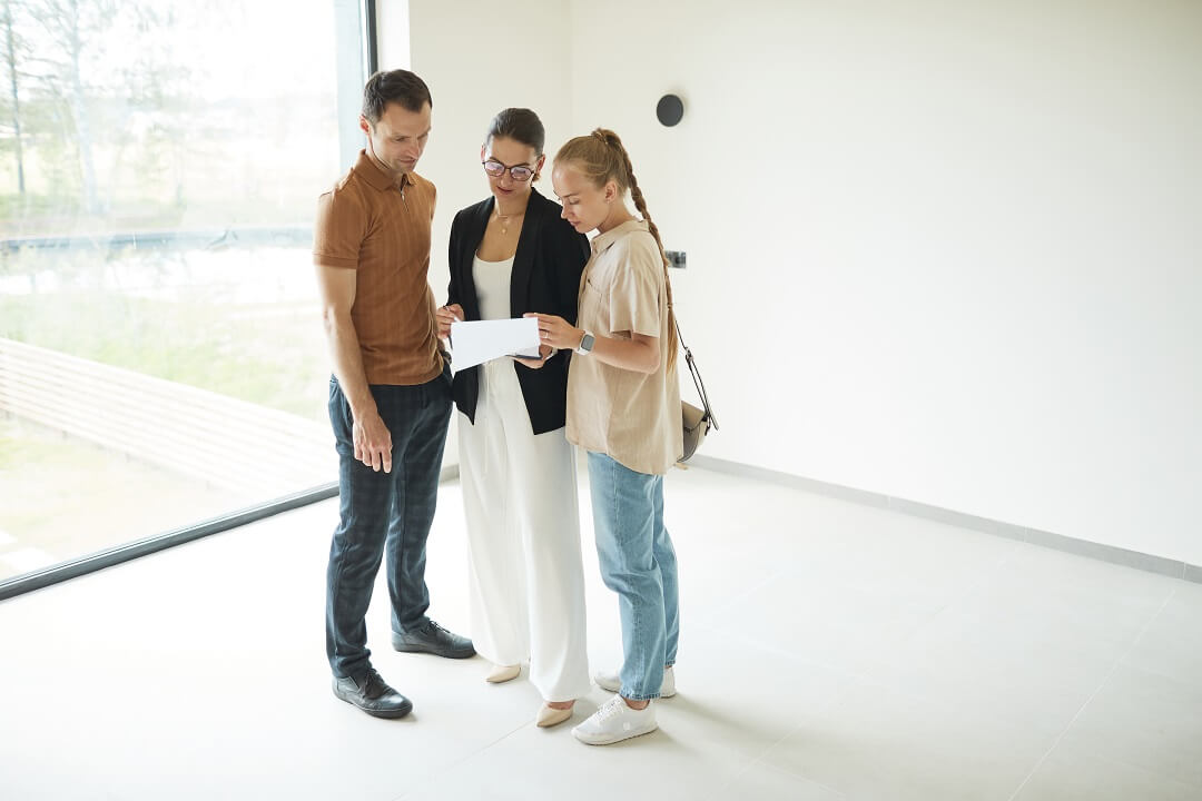 Couple talking to an agent about buying a house