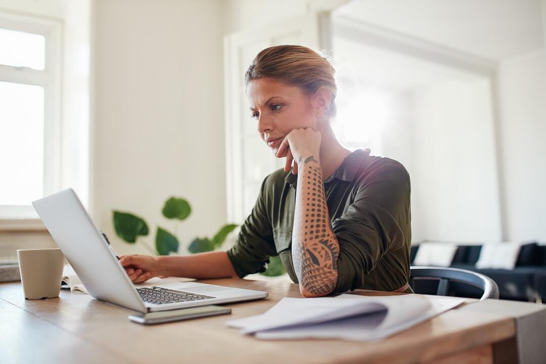 Federal employee woman checking her loan eligibility on a laptop.