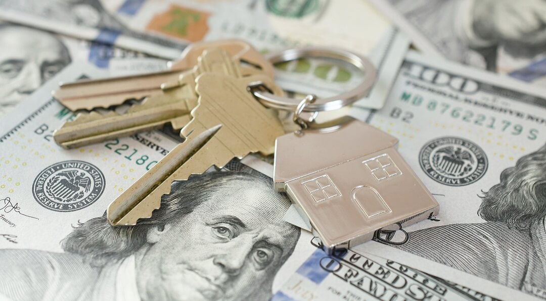 House keys on money for home refinance.