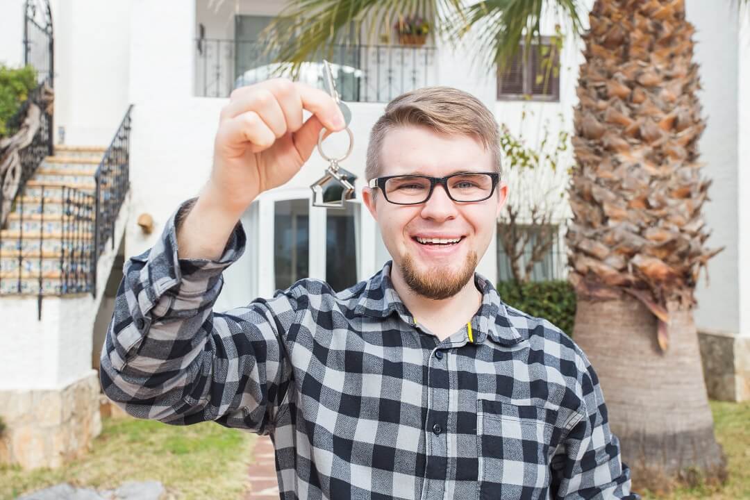 Male federal employee holding keys to new home