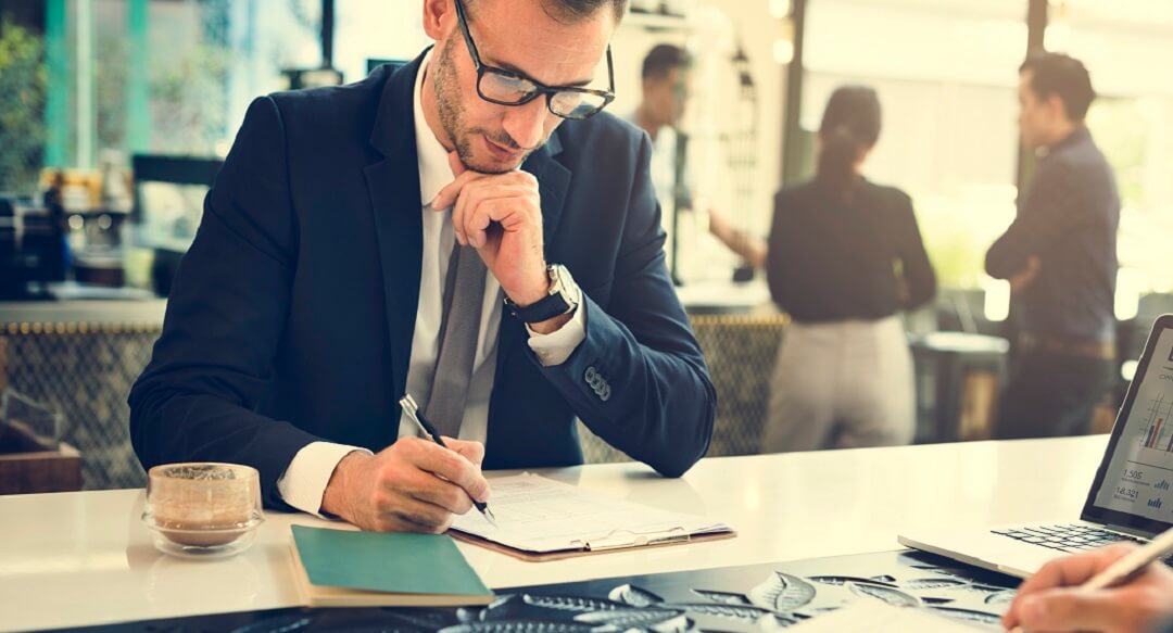 Man filling out forms in a business office