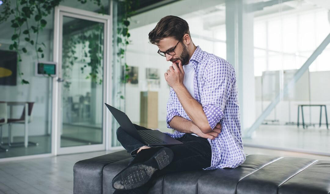 Man on laptop checking for his mortgage approval.