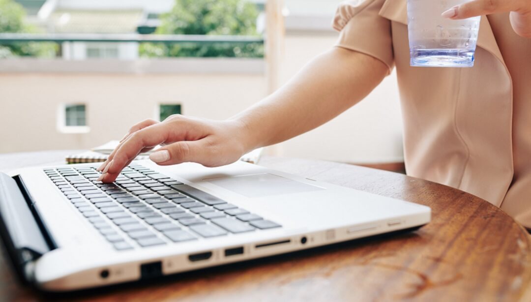 Woman checking websites for cheap apartment for rent.