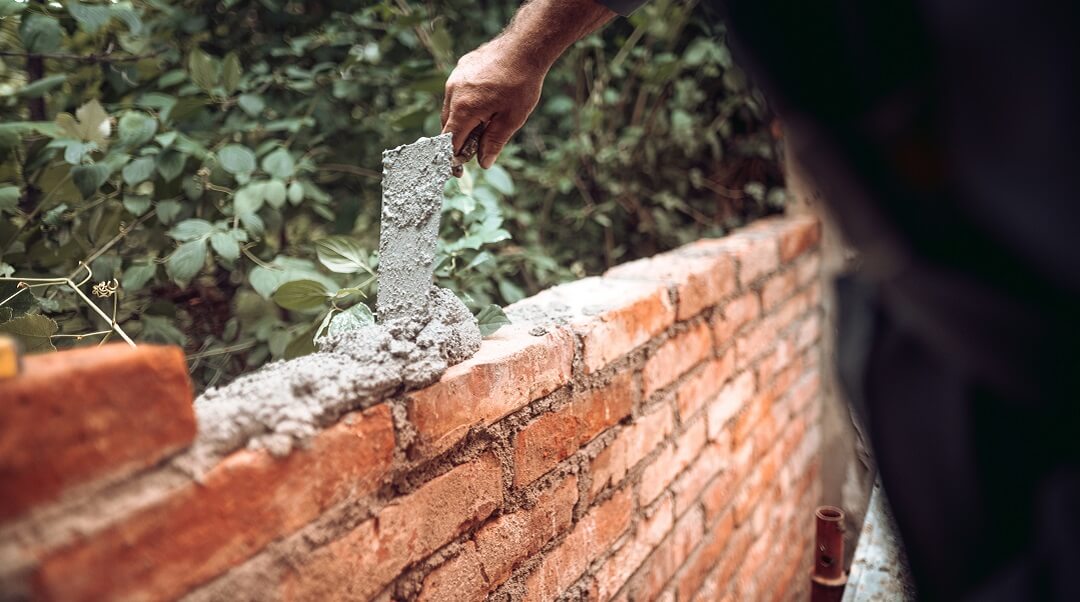 Worker building a brick home