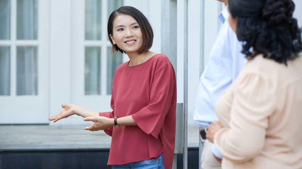 Young lady showing house to relatives.